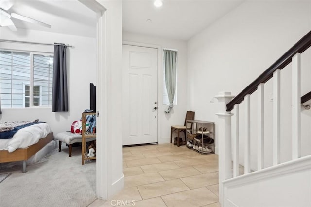 tiled foyer entrance featuring ceiling fan