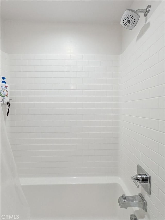 bathroom featuring shower / bathtub combination with curtain