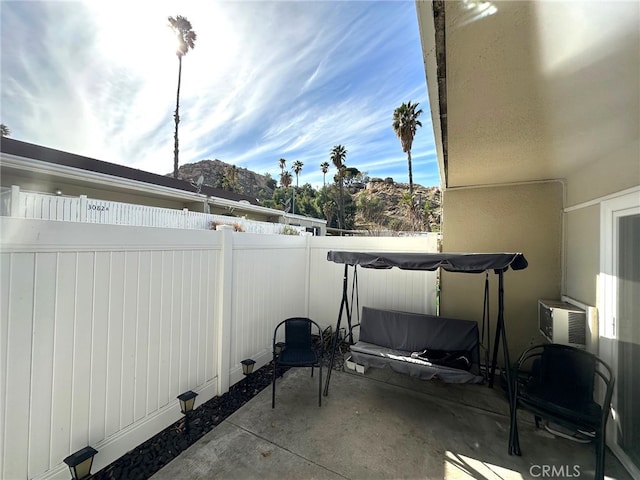 view of patio with cooling unit and a fenced backyard