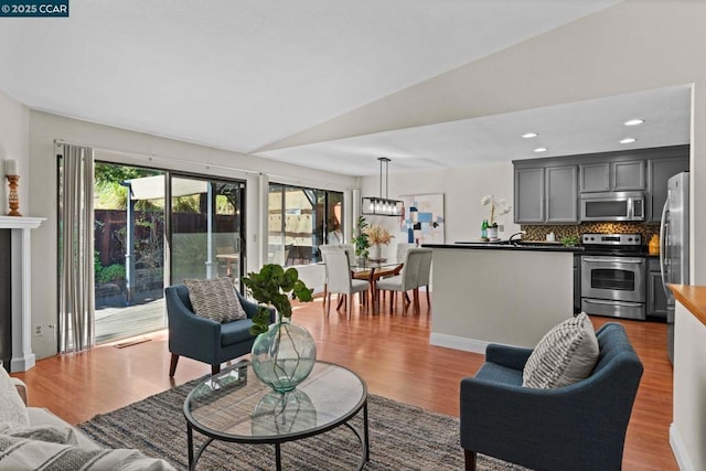 living room with lofted ceiling and hardwood / wood-style floors