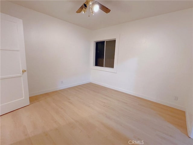 spare room featuring ceiling fan and light hardwood / wood-style flooring