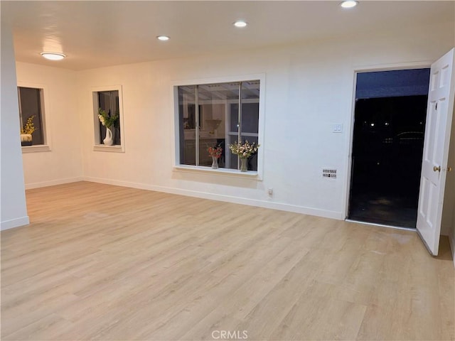 spare room with light wood-type flooring