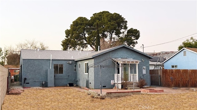 back of house with a lawn