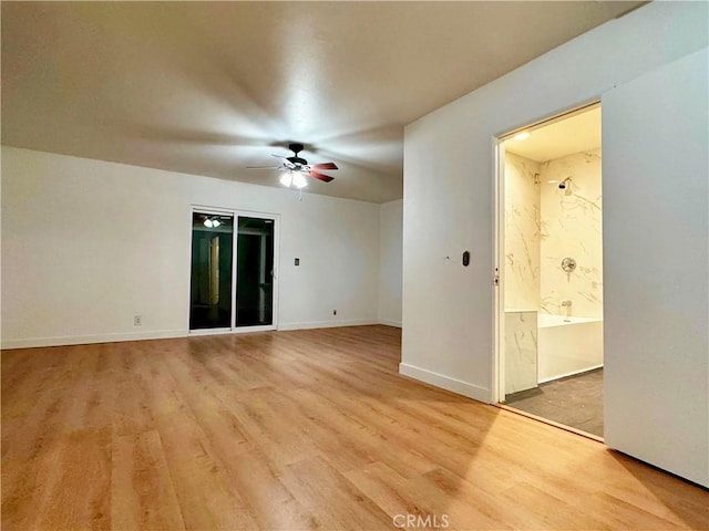 empty room with ceiling fan and hardwood / wood-style floors