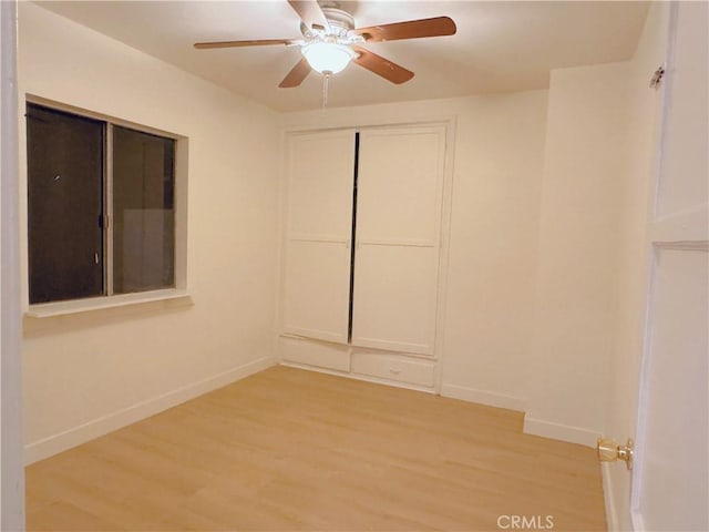 spare room with ceiling fan and light wood-type flooring