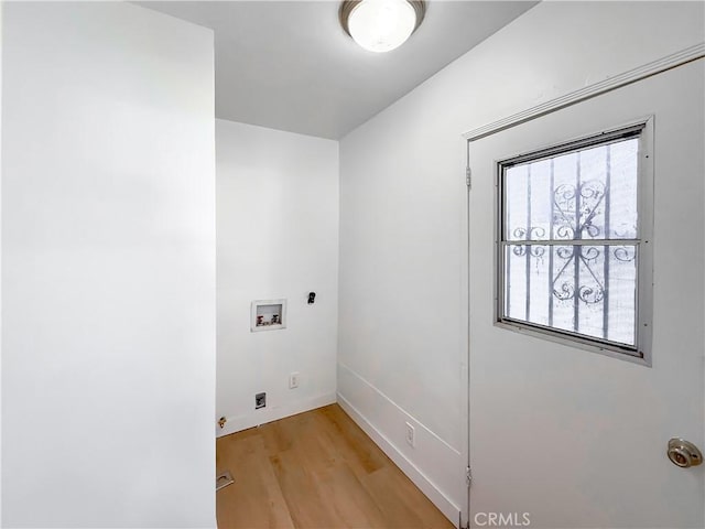 laundry area with laundry area, washer hookup, baseboards, and light wood-type flooring