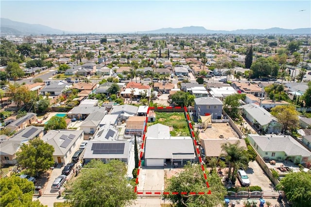 drone / aerial view featuring a residential view and a mountain view