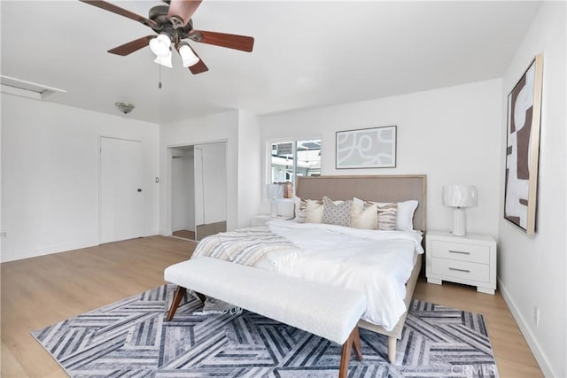 bedroom featuring light wood-style flooring, a closet, and a ceiling fan