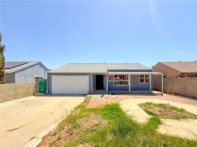single story home featuring a garage, fence, and concrete driveway
