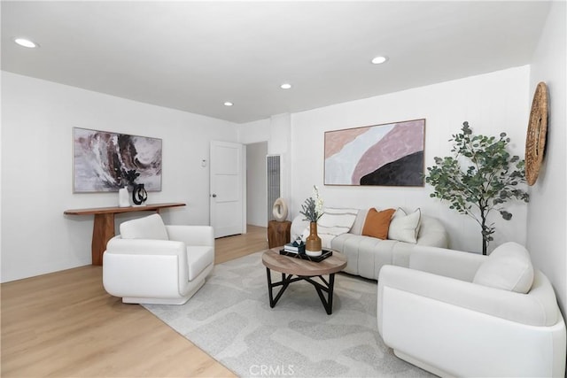 living area with light wood-style flooring and recessed lighting