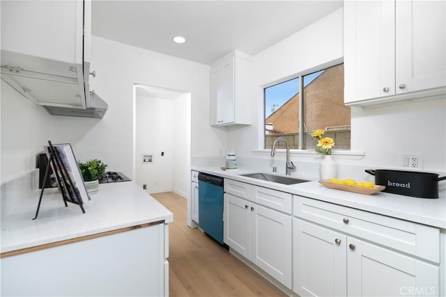 kitchen featuring light countertops, white cabinetry, light wood-style floors, dishwashing machine, and a sink
