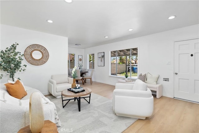 living area with recessed lighting and light wood-type flooring