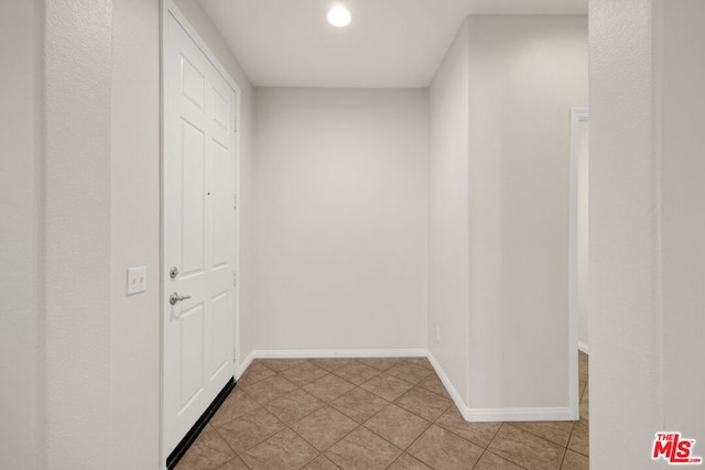 hallway featuring light tile patterned floors