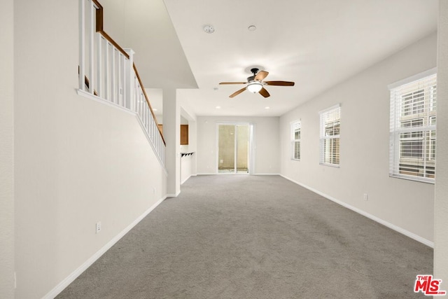 unfurnished living room with ceiling fan and carpet floors