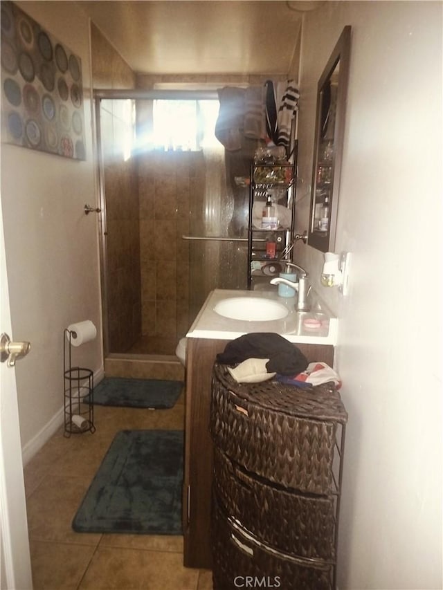 bathroom featuring vanity, tile patterned floors, and a shower with door