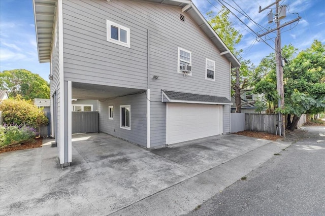 view of side of home with cooling unit and a garage