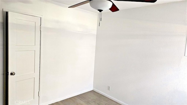 spare room featuring hardwood / wood-style floors and ceiling fan