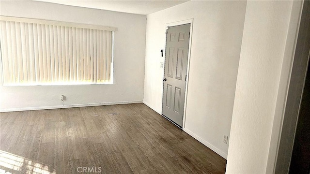 spare room featuring dark wood-type flooring