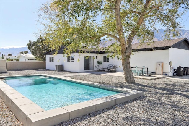 view of swimming pool with a patio area and central air condition unit