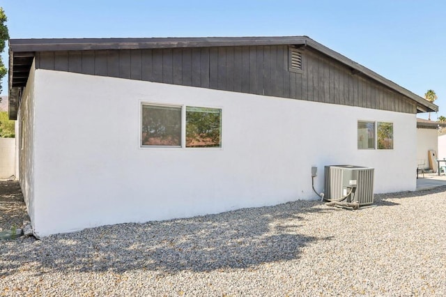 view of side of property with central air condition unit