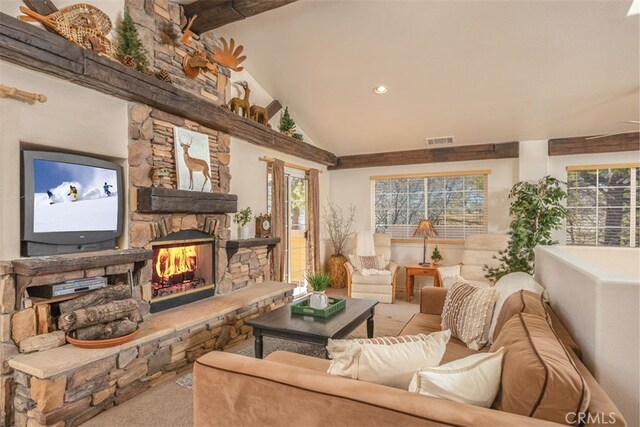 living room with light colored carpet, a stone fireplace, and vaulted ceiling with beams