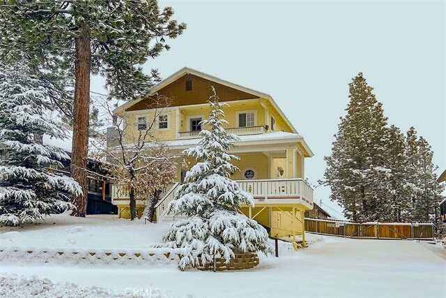 view of front of house with a balcony and covered porch