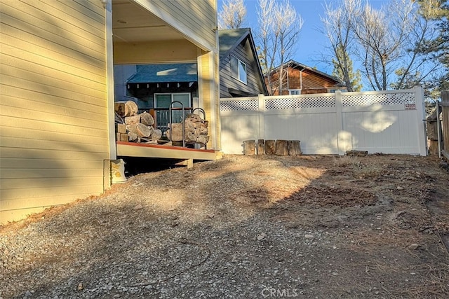 view of side of home featuring fence