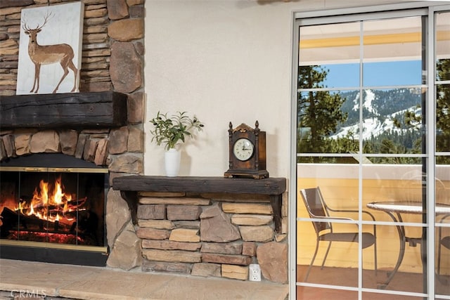 room details featuring a stone fireplace and a mountain view