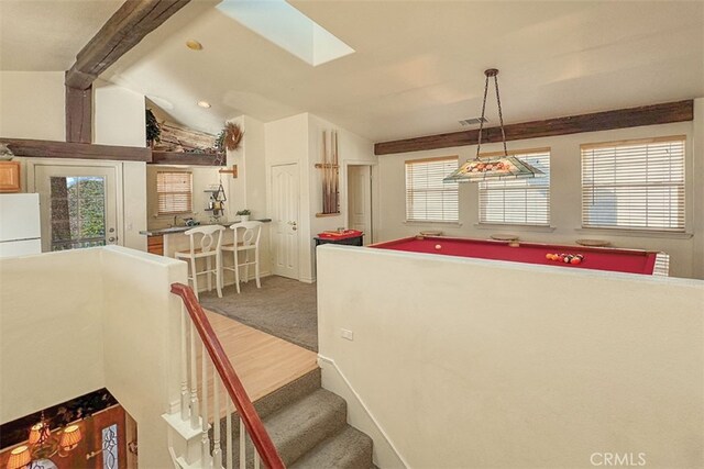 interior space with lofted ceiling with skylight, carpet flooring, and billiards