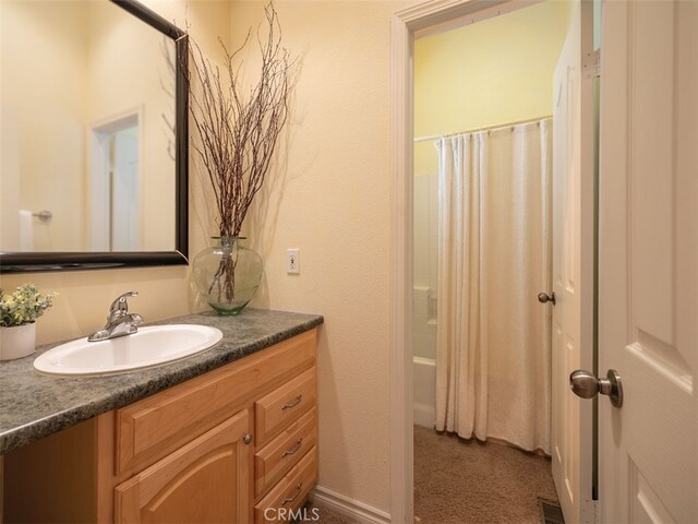 bathroom with vanity and shower / bath combo