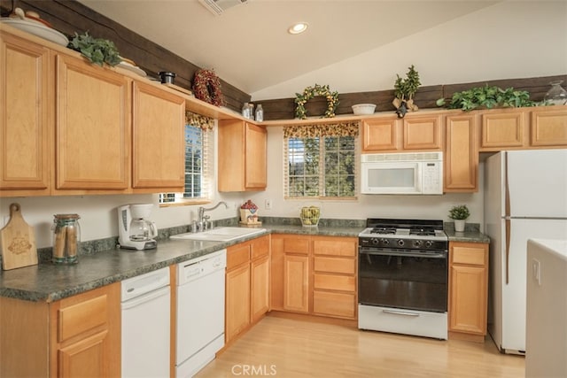 kitchen with sink, white appliances, light hardwood / wood-style floors, vaulted ceiling, and light brown cabinets