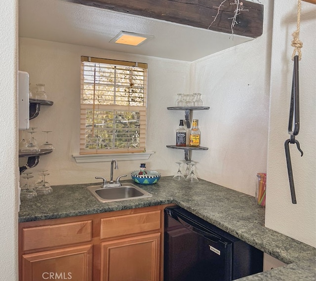 kitchen with dark countertops, open shelves, brown cabinetry, and a sink