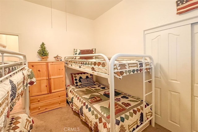 carpeted bedroom featuring vaulted ceiling