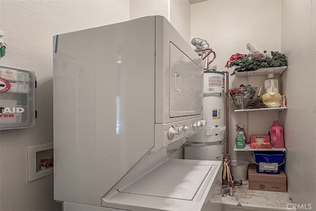 laundry area with laundry area, a textured wall, and stacked washer and clothes dryer