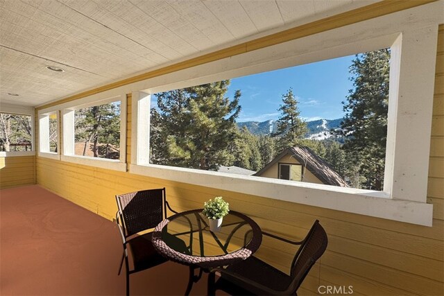 sunroom featuring a mountain view