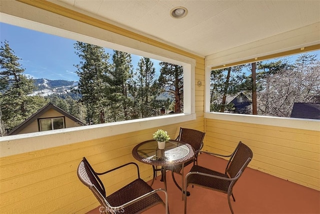 sunroom featuring a mountain view