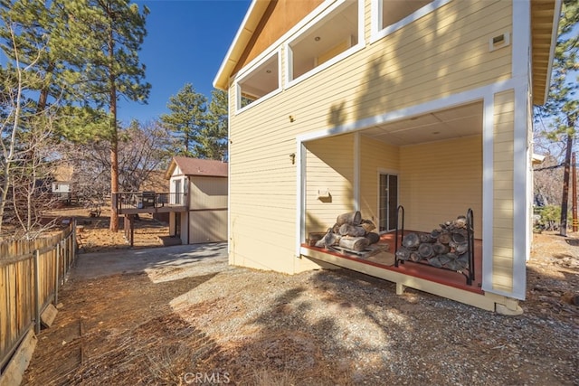 view of outbuilding featuring fence