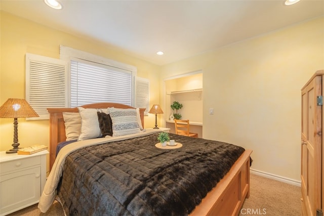 bedroom with baseboards, recessed lighting, and light colored carpet