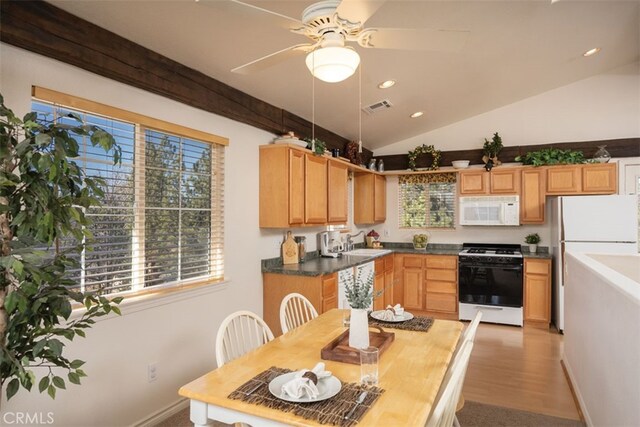 kitchen featuring lofted ceiling, sink, ceiling fan, light hardwood / wood-style floors, and white appliances