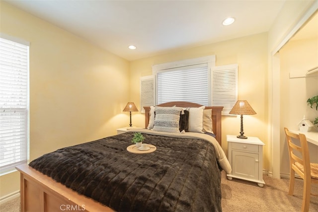 bedroom featuring light carpet and recessed lighting