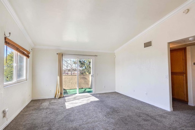 empty room featuring crown molding and carpet flooring