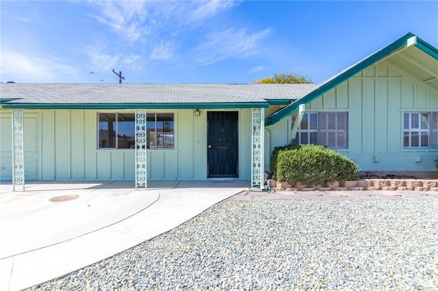 doorway to property featuring board and batten siding