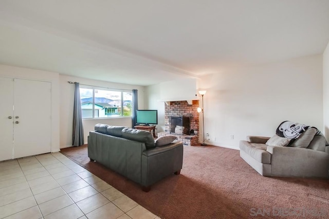 tiled living room featuring a brick fireplace