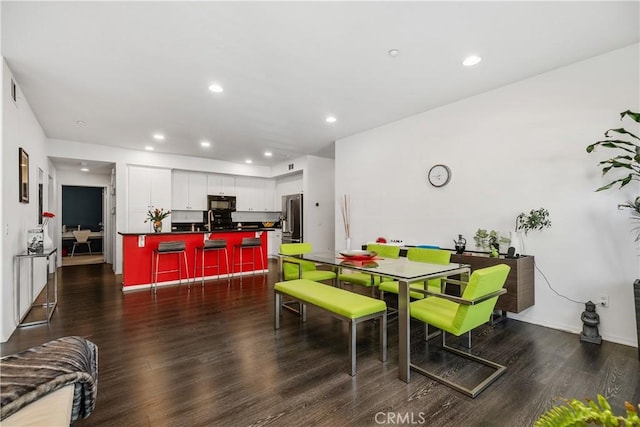 dining space featuring dark hardwood / wood-style flooring and sink