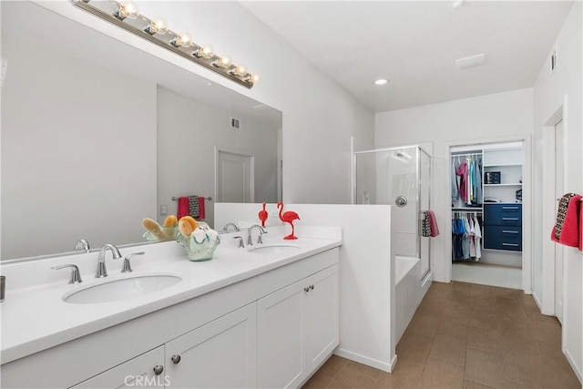 bathroom featuring independent shower and bath, vanity, and tile patterned flooring