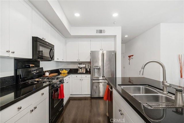 kitchen featuring white cabinetry, dark wood-type flooring, sink, and black appliances