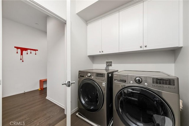 laundry room with cabinets, dark hardwood / wood-style flooring, and separate washer and dryer