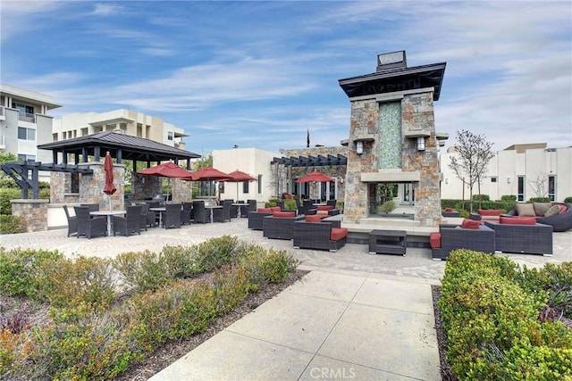 view of community featuring an outdoor living space and a patio area