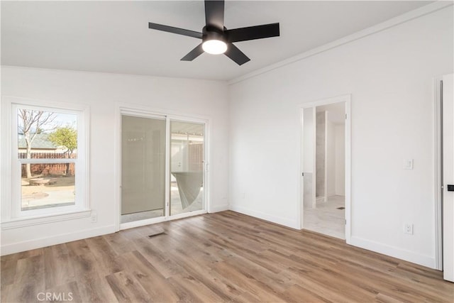 spare room featuring crown molding, ceiling fan, and light wood-type flooring