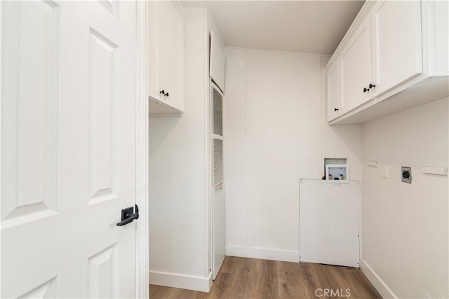 laundry room with cabinets, washer hookup, light wood-type flooring, and electric dryer hookup